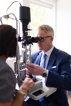 Dr. Peter Duffy Ophthalmologist Albany NY examining a patient at the slit lamp